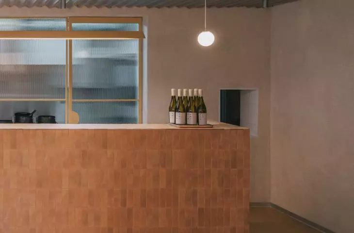 The minimalist bar is covered with tiles in a beige shade