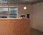 The minimalist bar is covered with tiles in a beige shade