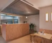 above the bar, the designer placed a corrugated metal ceiling