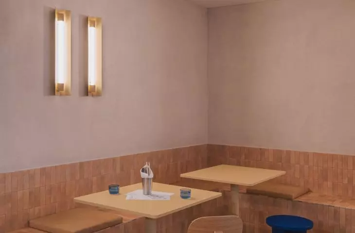 part of the walls is covered with a lampery of narrow, rectangular tiles in a beige shade
