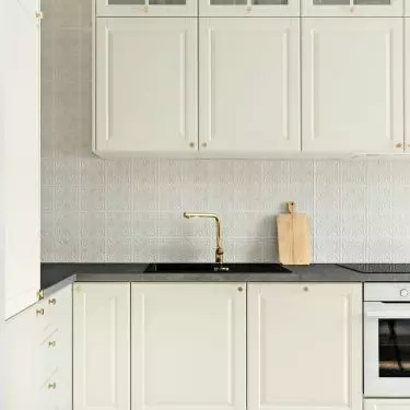 The floor in the kitchenette was tiled with patterned tiles