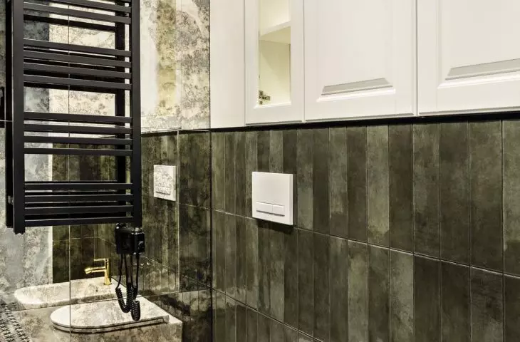 Green tiles on the wall combine with patterned tiles on the floor