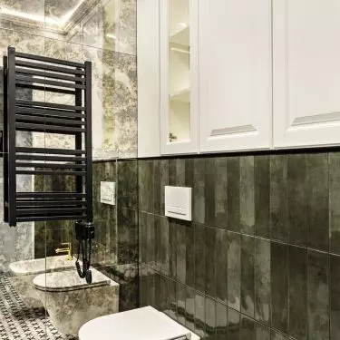 Green tiles on the wall combine with patterned tiles on the floor