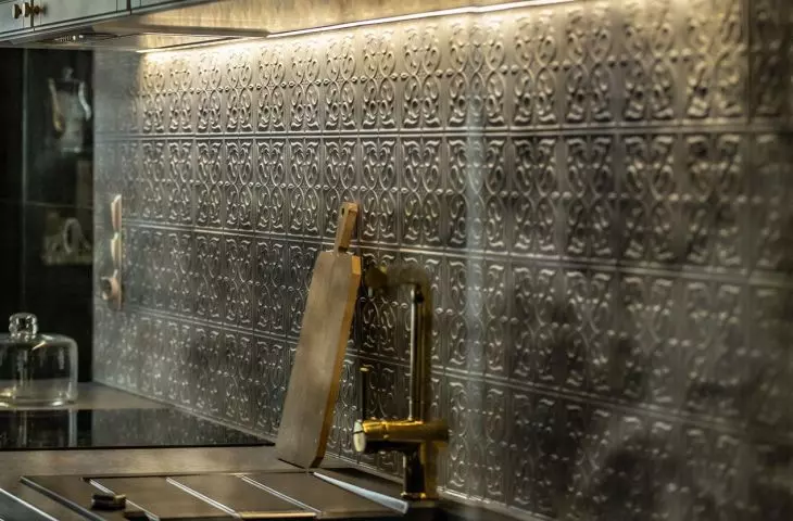 Tiles with a pattern also appear on the wall above the countertop