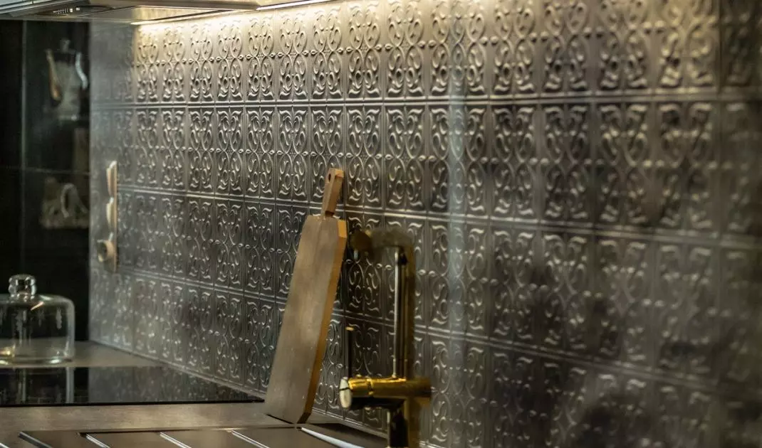 Tiles with a pattern also appear on the wall above the countertop