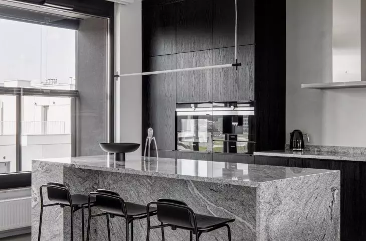 The kitchen is kept in shades of gray and black