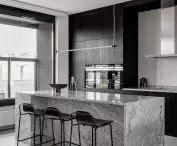 The kitchen is kept in shades of gray and black