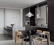 Black dining table continues the layout of the kitchen island