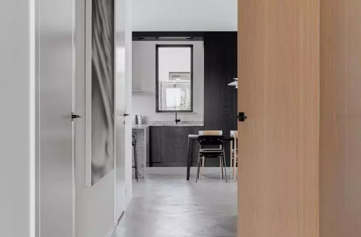View from the hallway toward the kitchen, on the floor microcement