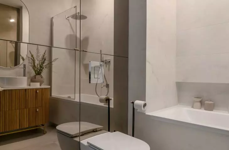 Mirrored fronts of the toilet enclosure optically enlarge the space