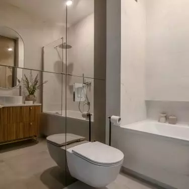Mirrored fronts of the toilet enclosure optically enlarge the space