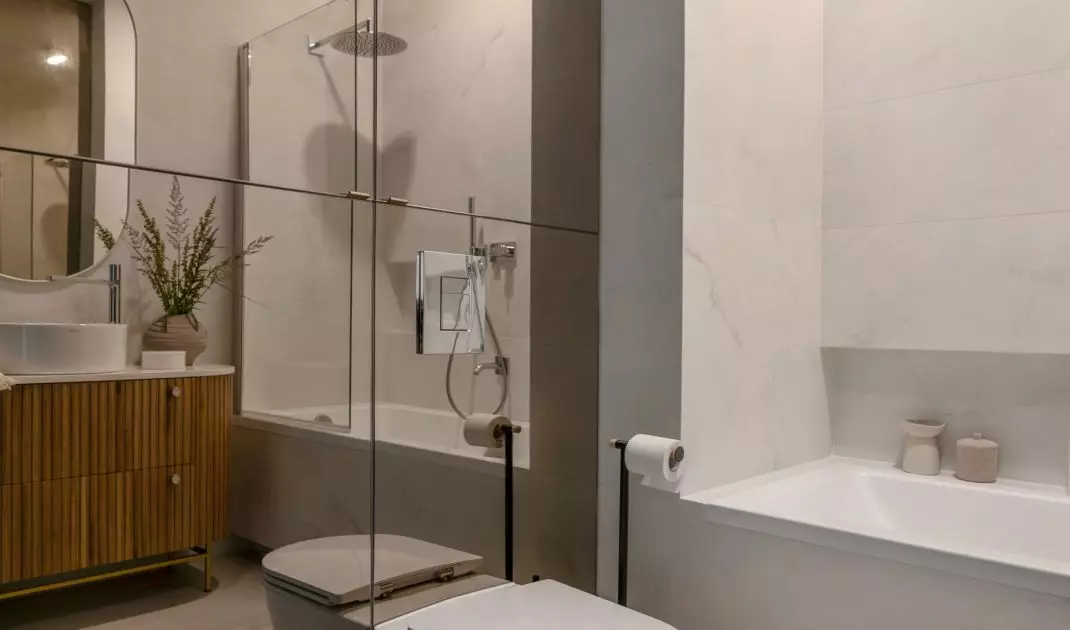 Mirrored fronts of the toilet enclosure optically enlarge the space