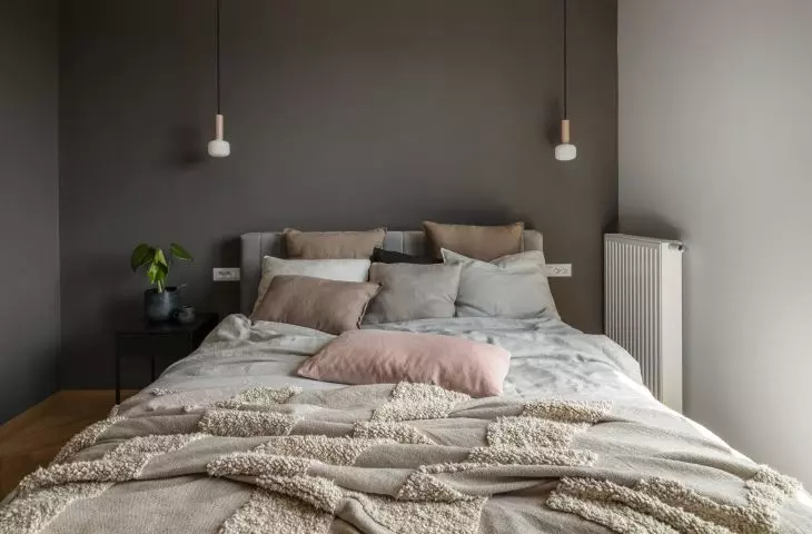 The focal point of the bedroom is a large upholstered bed
