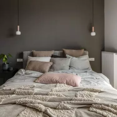 The focal point of the bedroom is a large upholstered bed