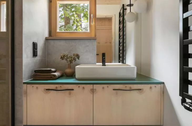 The sink cabinet has a green top