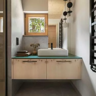 The sink cabinet has a green top