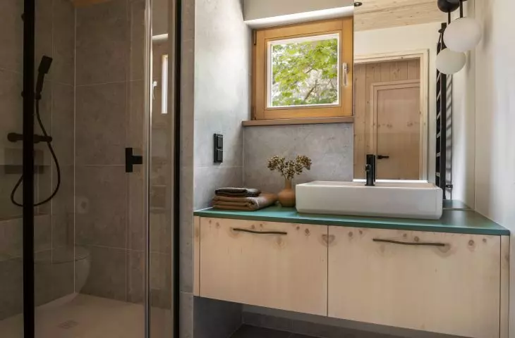 The bathroom was lined with gray large-format tiles