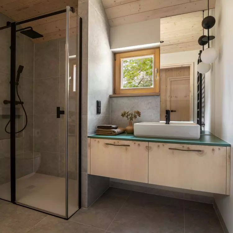 The bathroom was lined with gray large-format tiles