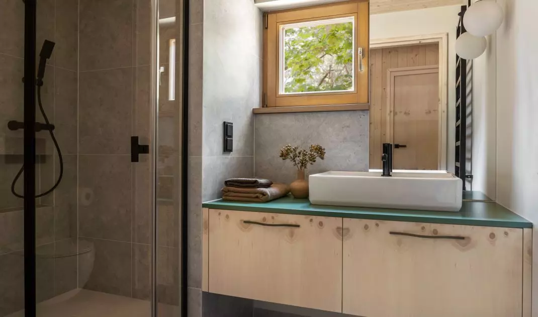 The bathroom was lined with gray large-format tiles