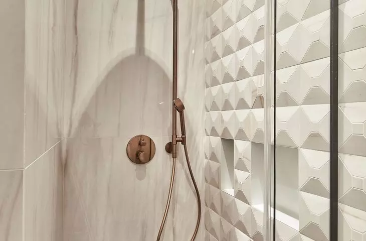 The wall of the shower was lined with three-dimensional tiles