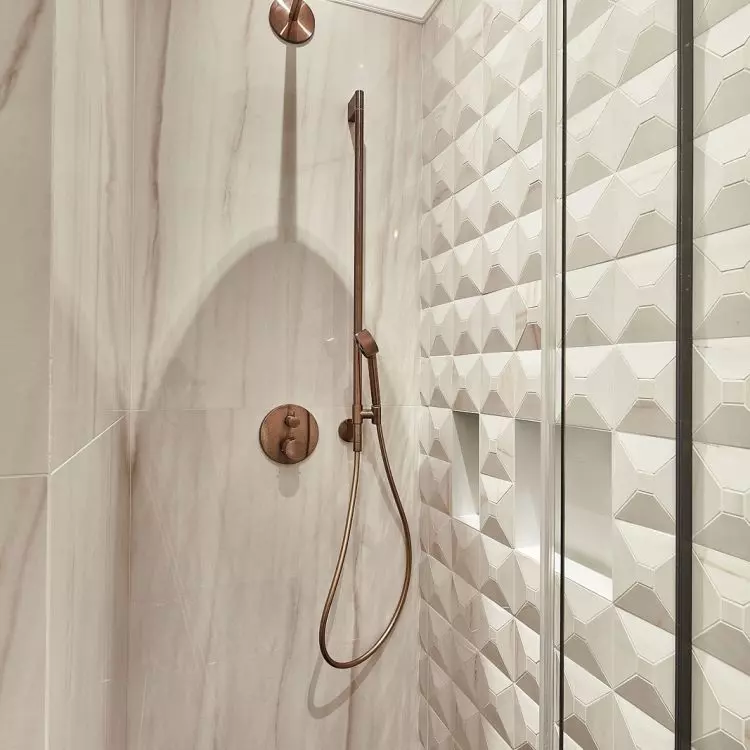 The wall of the shower was lined with three-dimensional tiles