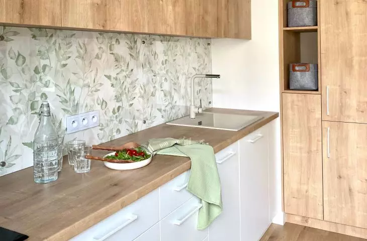 Wooden fronts of built-in furniture warm up the space