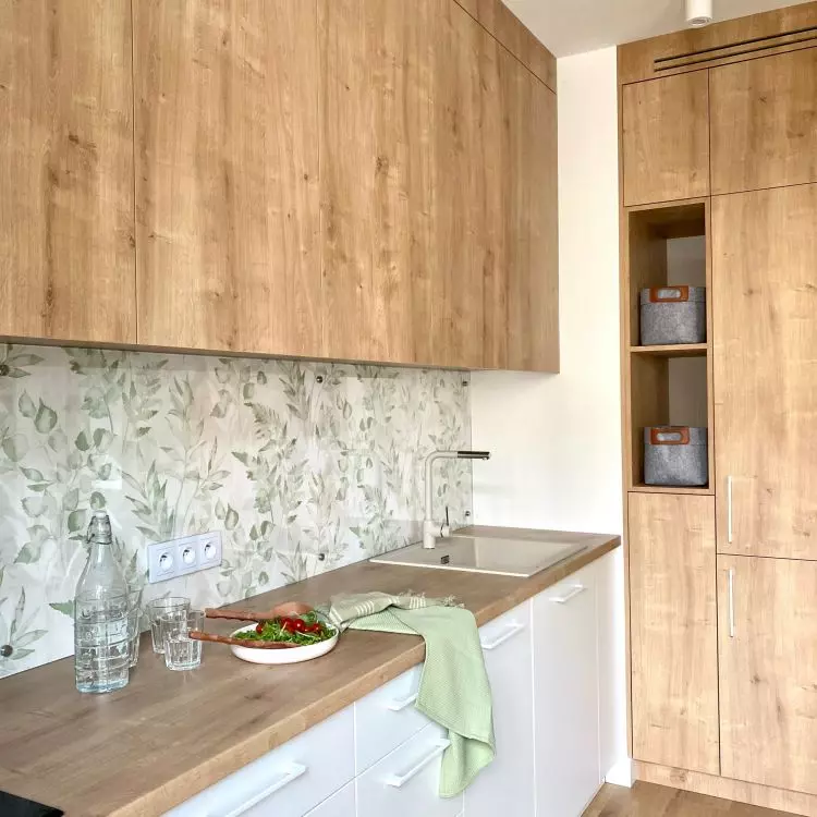 Wooden fronts of built-in furniture warm up the space