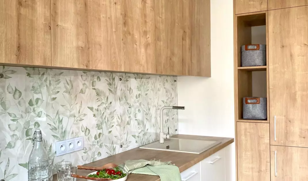 Wooden fronts of built-in furniture warm up the space
