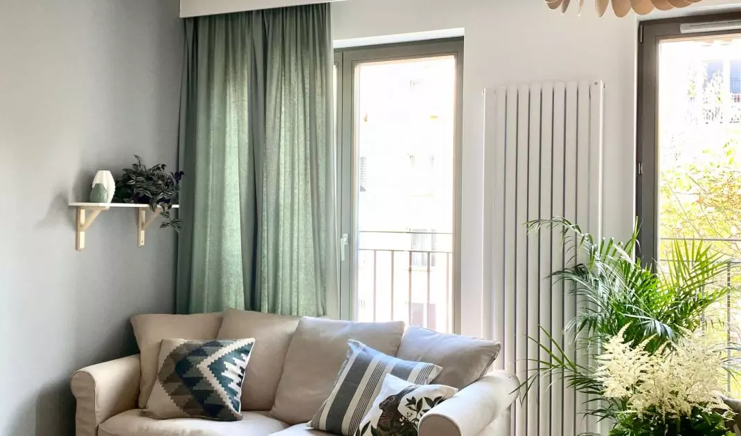 Simple sofa and modern coffee tables combine with minimalist kitchen