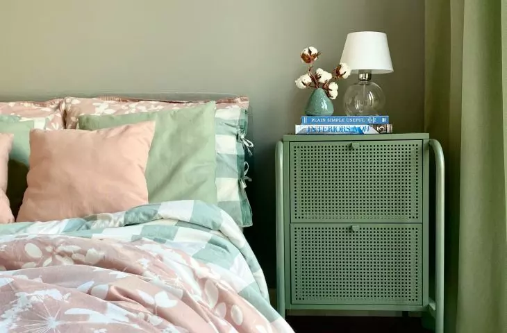 The bedroom is bathed in various shades of green