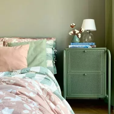 The bedroom is bathed in various shades of green