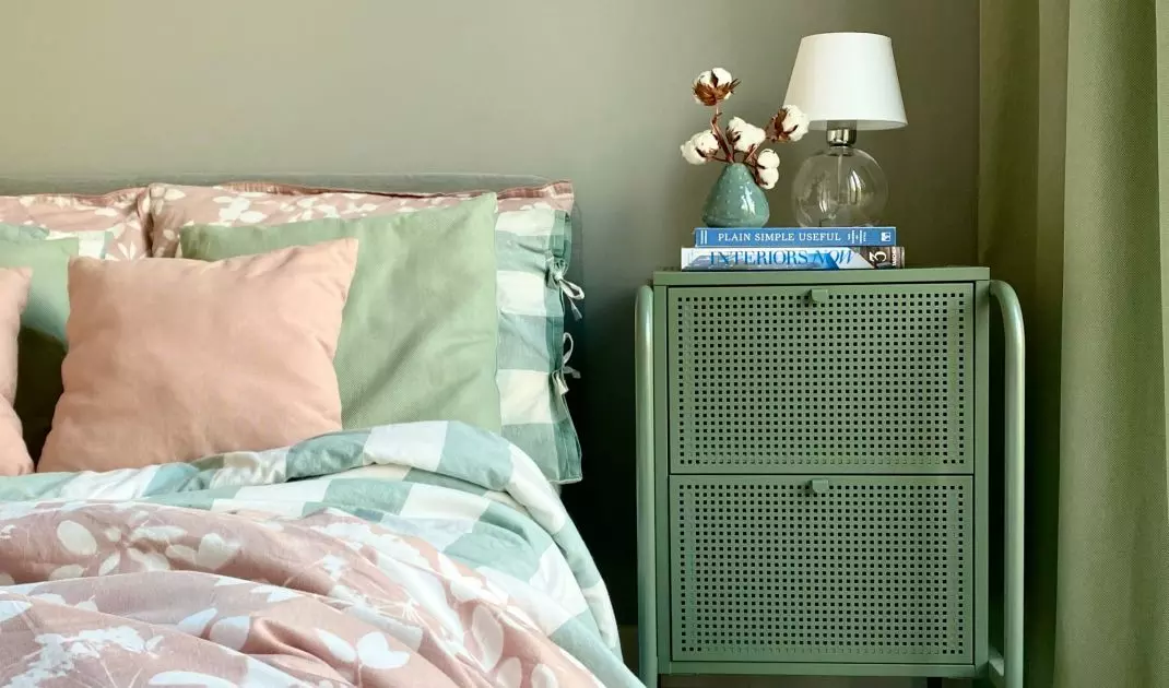 The bedroom is bathed in various shades of green