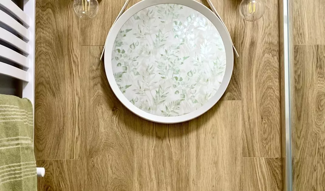 The bathroom design is dominated by wood