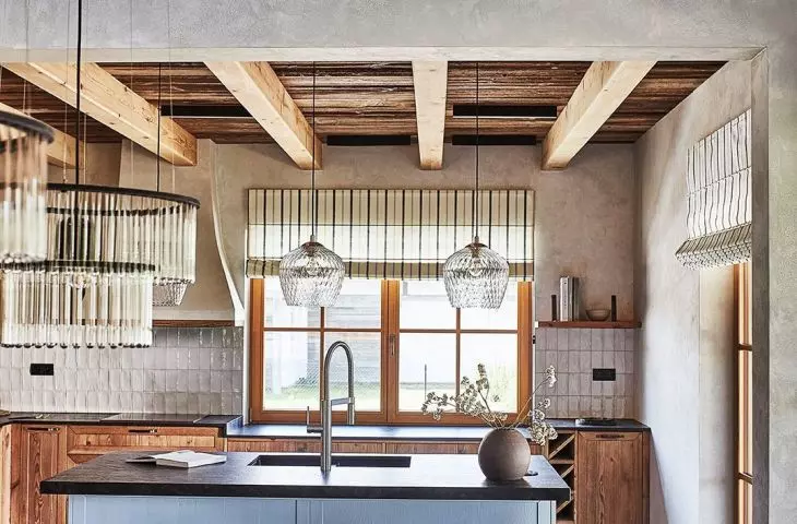 The kitchen is separated from the dining room by a chimney wall made of hewn stone