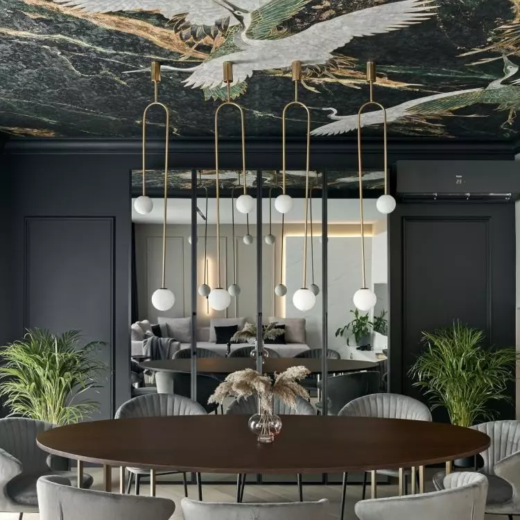 On the ceiling there is wallpaper in cranes