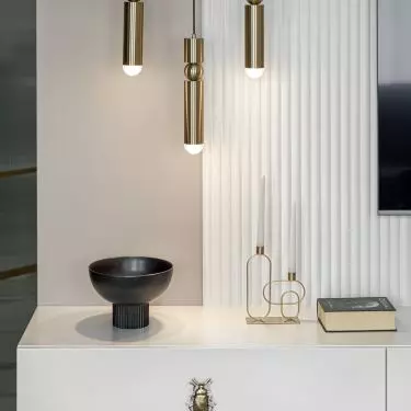 The wall with the tv is decorated with fluting