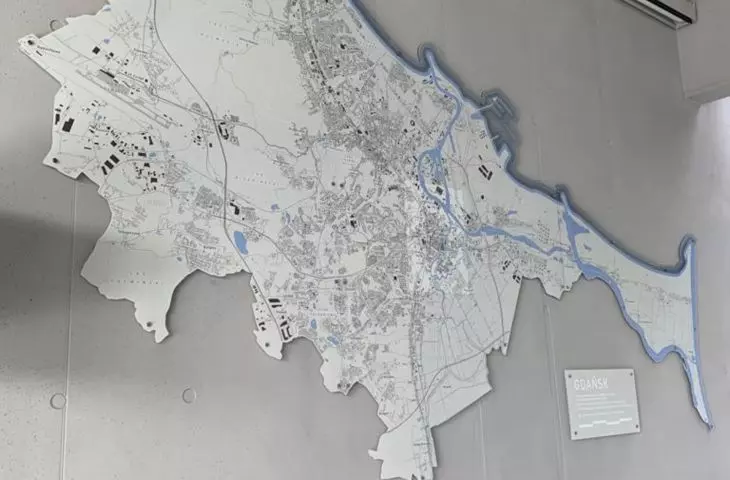 The room with the model also includes a map of the city
