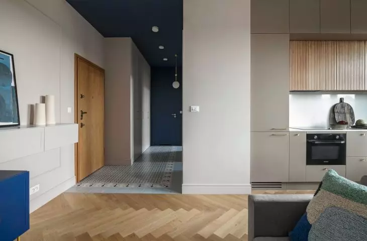 The hallway is distinguished by a navy blue ceiling and patterned tiles on the floor