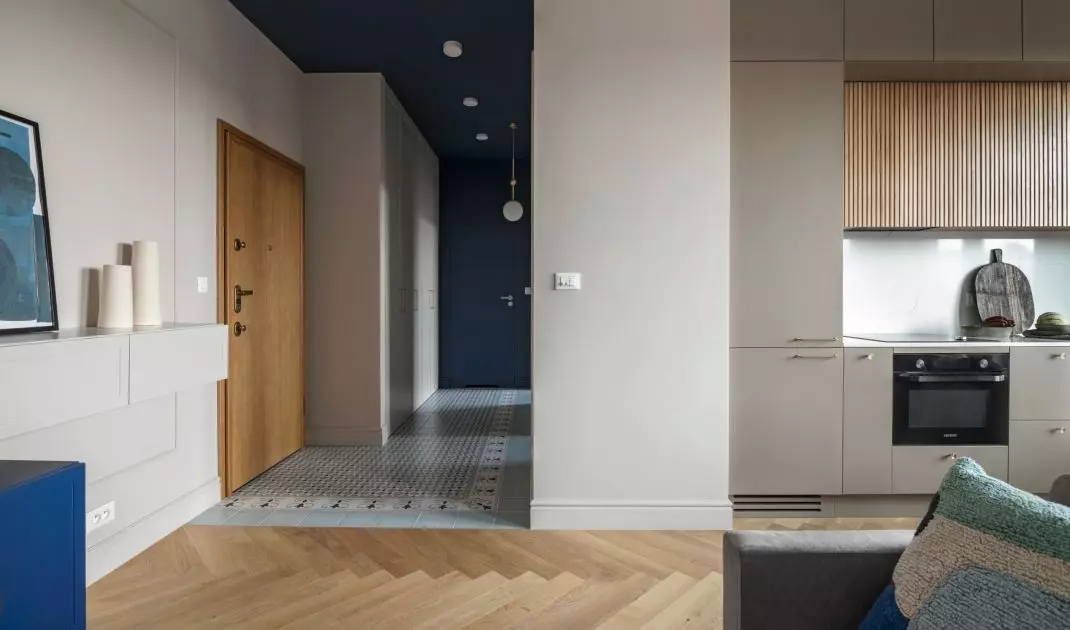The hallway is distinguished by a navy blue ceiling and patterned tiles on the floor