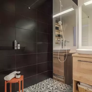 The bathroom floor was tiled with ornamental tiles