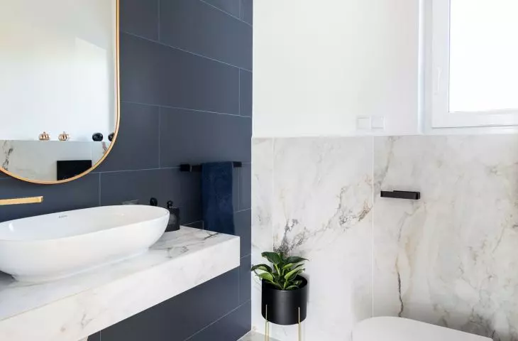 The walls and floor were tiled with a marble pattern
