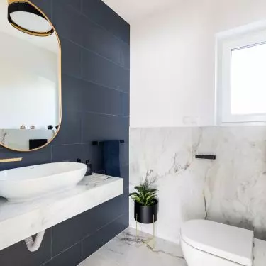 The walls and floor were tiled with a marble pattern