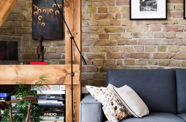 Brick on the wall blends in with many styles used for living room design