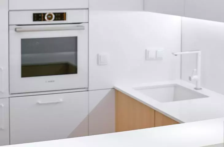Kitchen cabinetry is a combination of white and oak wood