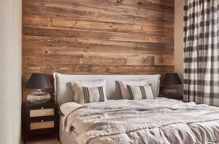 The wall behind the bed was lined with boards