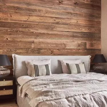 The wall behind the bed was lined with boards