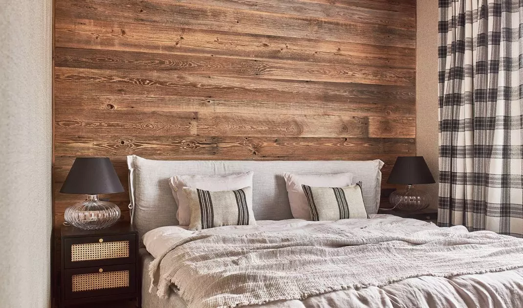 The wall behind the bed was lined with boards