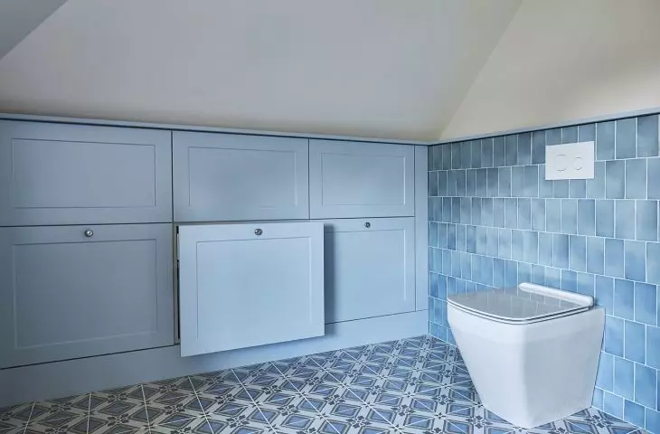 The bathroom also has blue built-ins