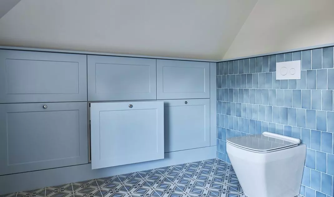 The bathroom also has blue built-ins