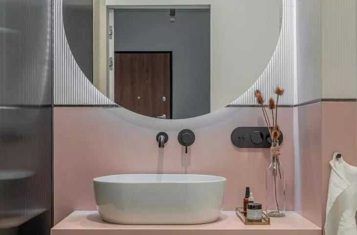 The bathroom is dominated by a combination of pink and white